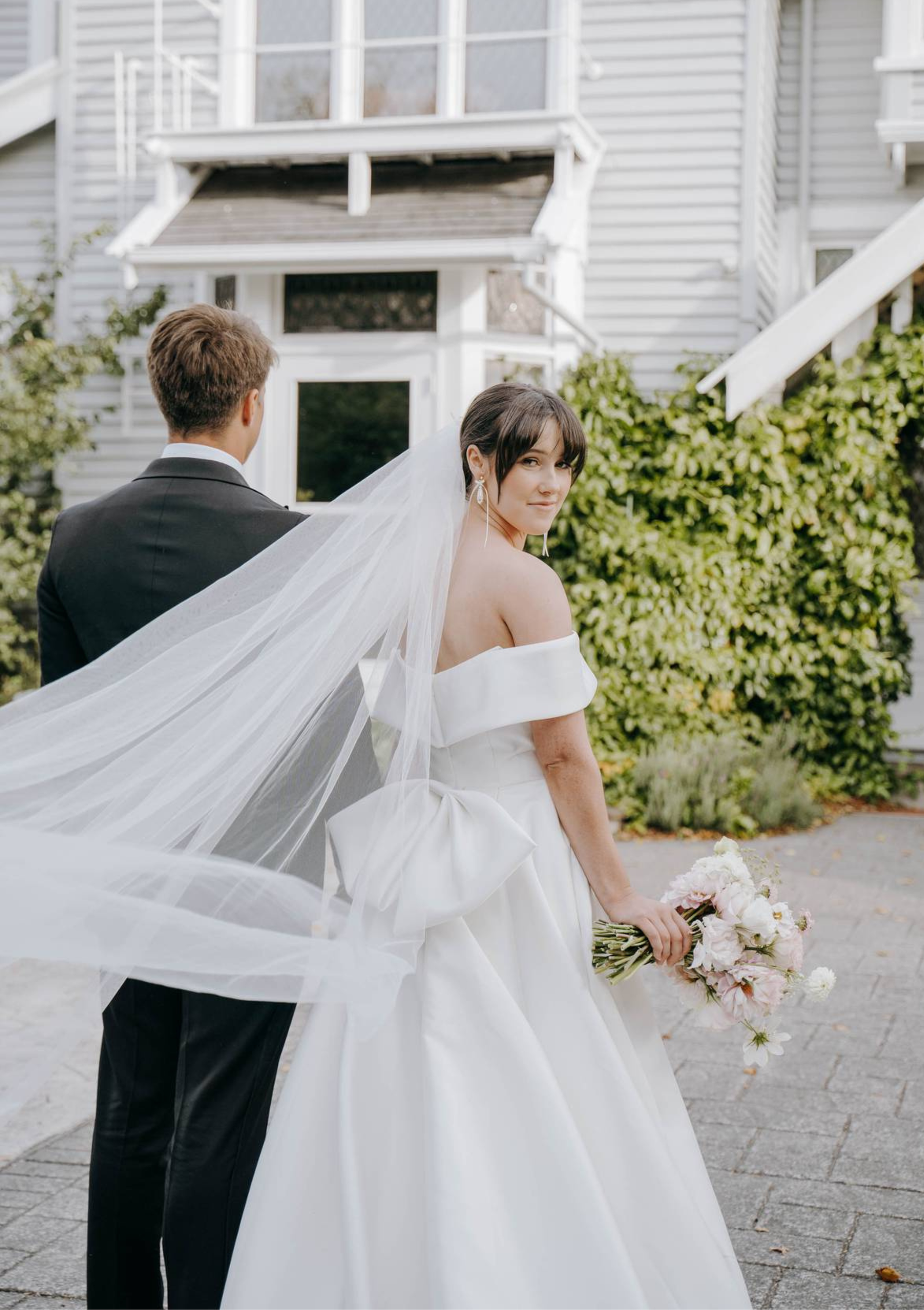 Floaty tulle cathedral veil side view, bridal updo with loose waves